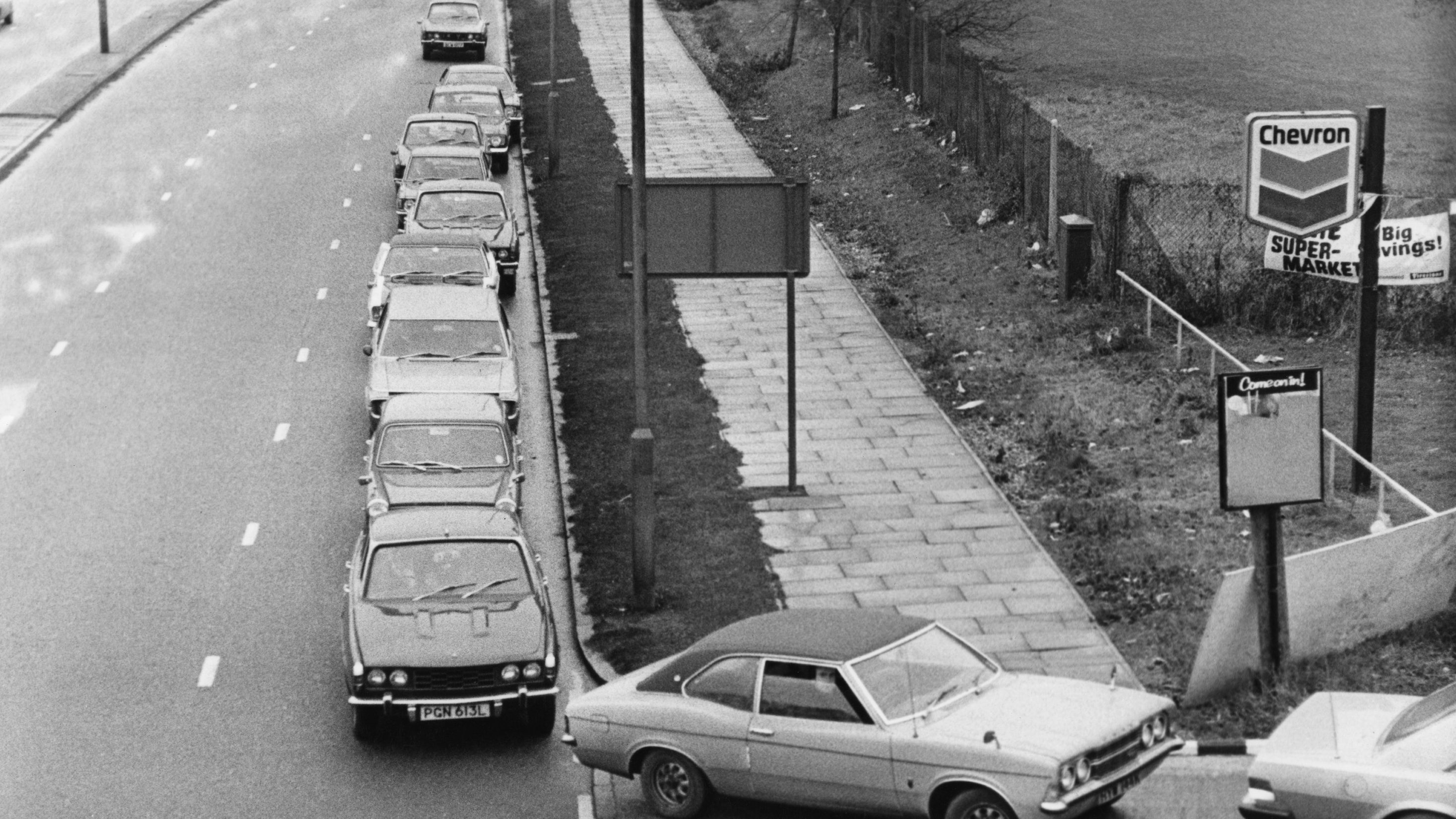 5th December 1973:  Cars queuing for fuel during the oil crisis of 1973. (Evening Standard/Getty Images)