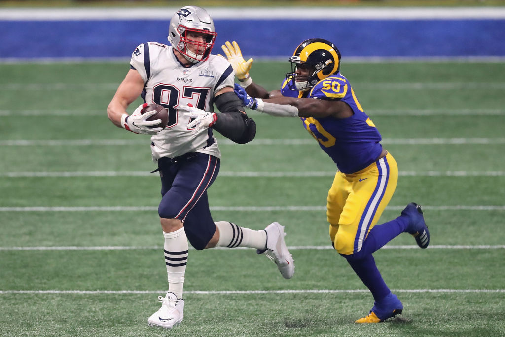 ATLANTA, GA - FEBRUARY 03: Rob Gronkowski #87 of the New England Patriots runs the ball against Samson Ebukam #50 of the Los Angeles Rams in the second half during Super Bowl LIII at Mercedes-Benz Stadium on February 3, 2019 in Atlanta, Georgia.  (Photo by Elsa/Getty Images)