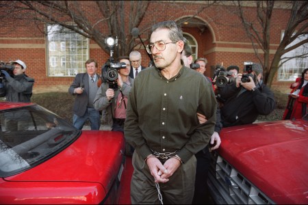 ALEXANDRIA, :  Former senior Central Intelligence Agency office Aldrich Hazen Ames is led from U.S. Federal Courthouse in Alexandria, 22 February 1994, after being arraigned on charges of spying for the former Soviet Union. Ames' wife, Mari del Rosario Casas Ames, was also arraigned on the same charges. Ames and his wife were charged with spying for the former Soviet Union since 1985 and receiving more than 1.5 million USD. (Getty Images)
