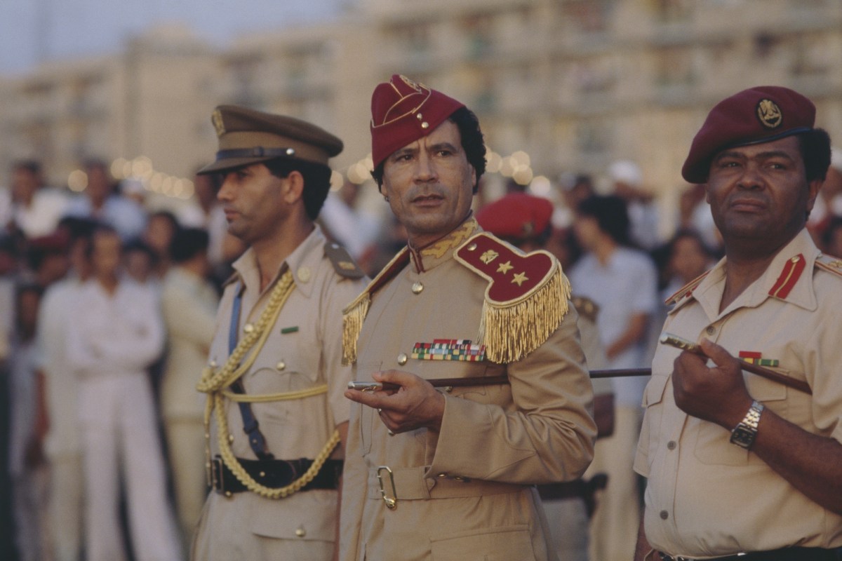 Libyan chief of state Muammar al-Qaddafi attends a 1981 graduation at the women's military academy in Tripoli. The academy opened in 1979 during Qaddafi's push to include women in Libya's armed forces. (Photo by Christine Spengler/Sygma/Sygma via Getty Images)