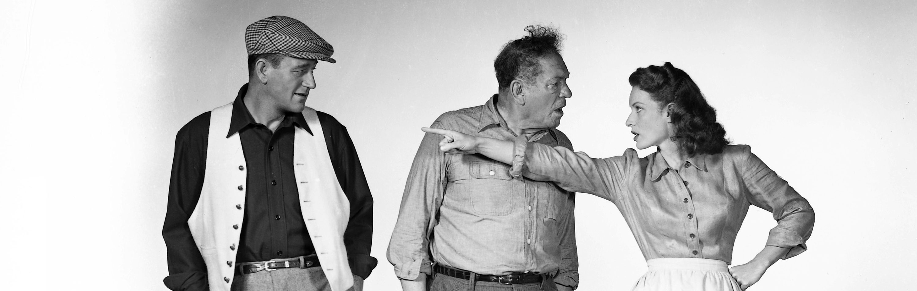 From left to right, actors John Wayne (1907 - 1979) as Sean Thornton, Victor McLaglen (1886 - 1959) as Squire 'Red' Will Danaher and Maureen O'Hara (1920 - 2015) as Mary Kate Danaher in a publicity still for the film 'The Quiet Man', 1952. (Photo by Silver Screen Collection/Getty Images)