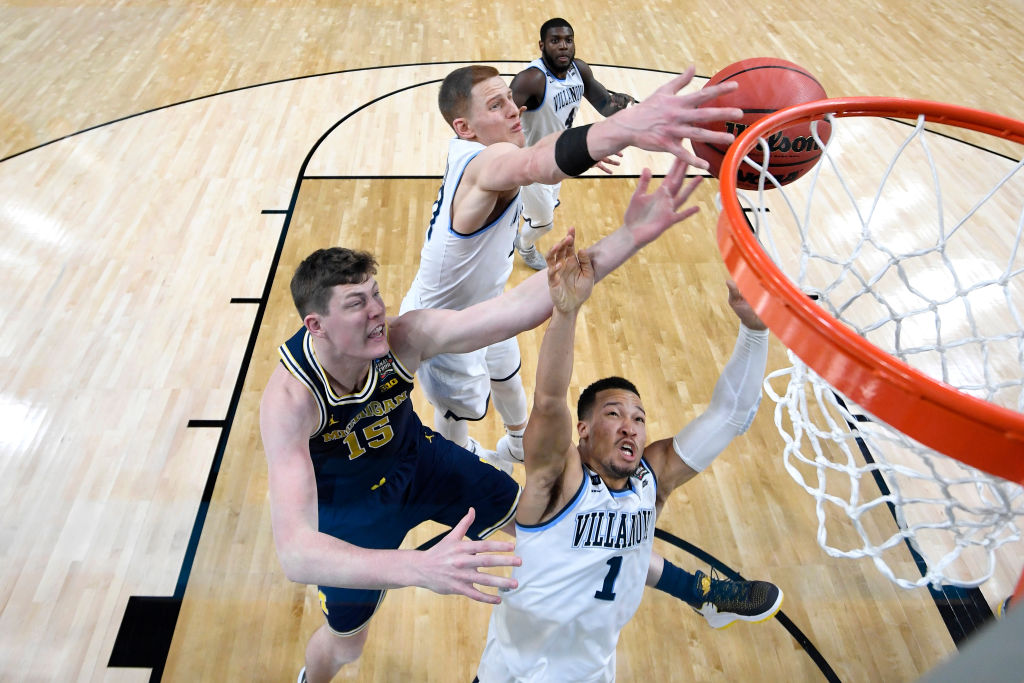 SAN ANTONIO, TX - APRIL 02: Jon Teske #15 of the Michigan Wolverines competes for the ball against Jalen Brunson #1 and Donte DiVincenzo #10 of the Villanova Wildcats during the second half of the 2018 NCAA Men's Final Four National Championship game at the Alamodome on April 2, 2018 in San Antonio, Texas.  (Photo by Brett Wilhelm/NCAA Photos via Getty Images)