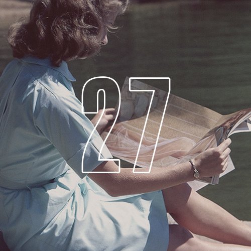 A woman reading a magazine, with an overlay of the number "27"