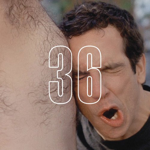 A man leaning on another man's bare chest, with an overlay of the number "36"