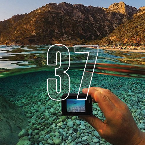 A first-person POV of a person taking an underwater picture at a beach, with an overlay of the number "37"