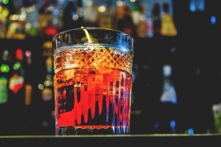 A collection of vermouth and quinquina bottles, including Noilly Prat Extra Dry, Lillet Blanc, Dolin Rouge, Martini & Rossi Rosso