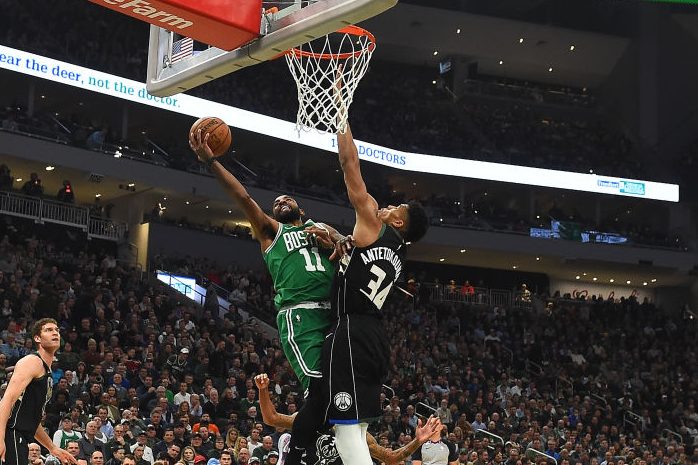 Kyrie Irving defended by Giannis Antetokounmpo. (Stacy Revere/Getty Images)