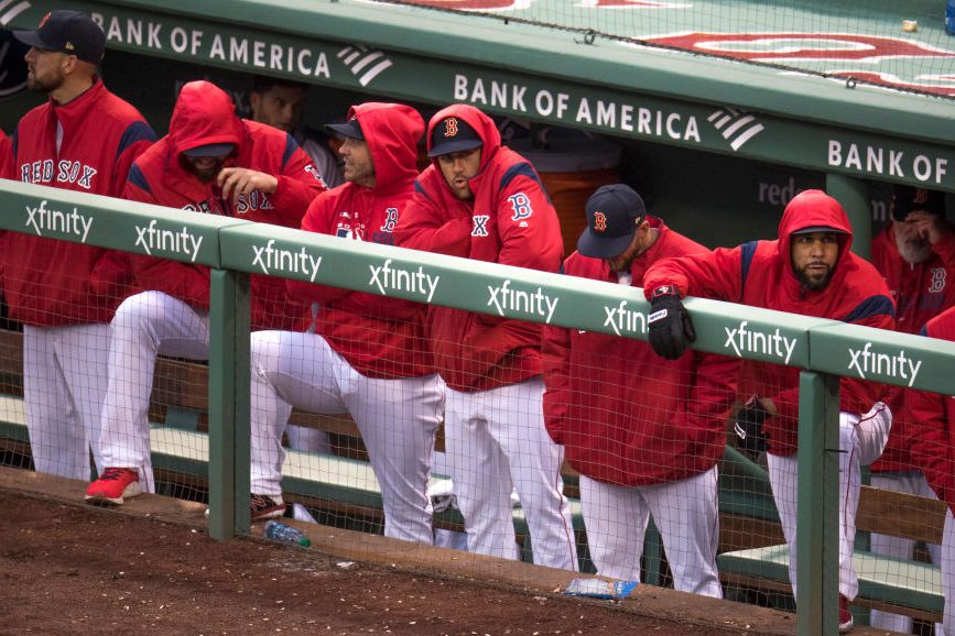 The Red Sox look on from the dugout during a loss. (Photo by Stan Grossfeld/The Boston Globe via Getty Images)