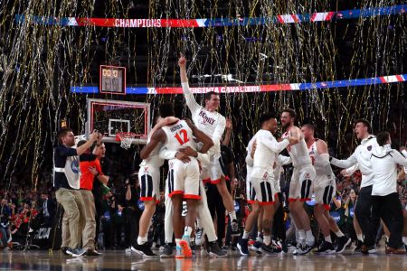 The Virginia Cavaliers celebrate their 85-77 win over Texas Tech. (Photo by Tom Pennington/Getty Images)