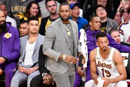 LeBron James in street clothes at a game. (Allen Berezovsky/Images)