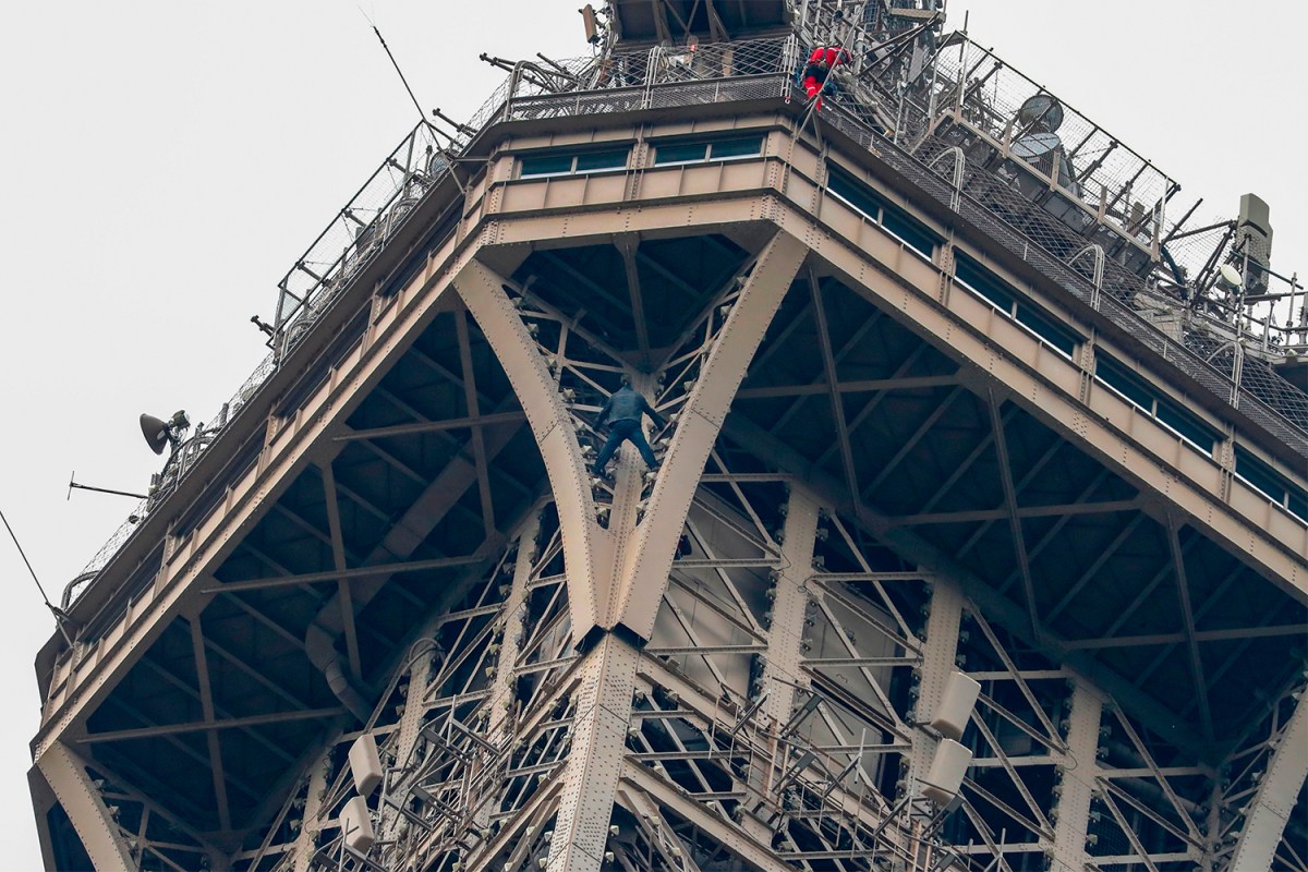 Climber Scales Side of Eiffel Tower