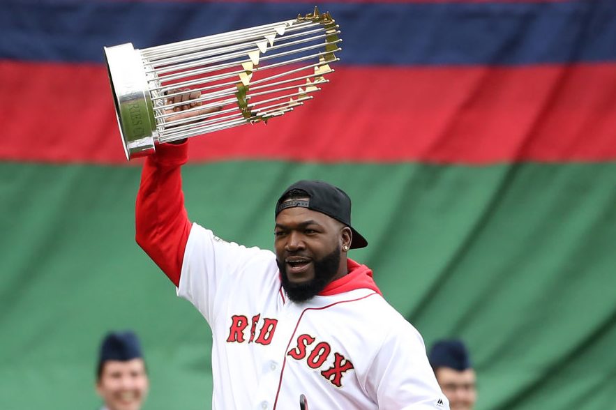 Ex-Red Sox player David Ortiz carries a World Series trophy. (Nancy Lane/MediaNews Group/Boston Herald via Getty)
