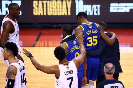 Kevin Durant #35 of the Golden State Warriors is assisted off the court. (Vaughn Ridley/Getty)