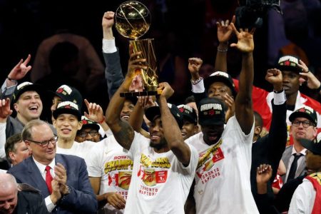 Kawhi Leonard celebrates with the Larry O'Brien Championship Trophy. (Lachlan Cunningham/Getty)
