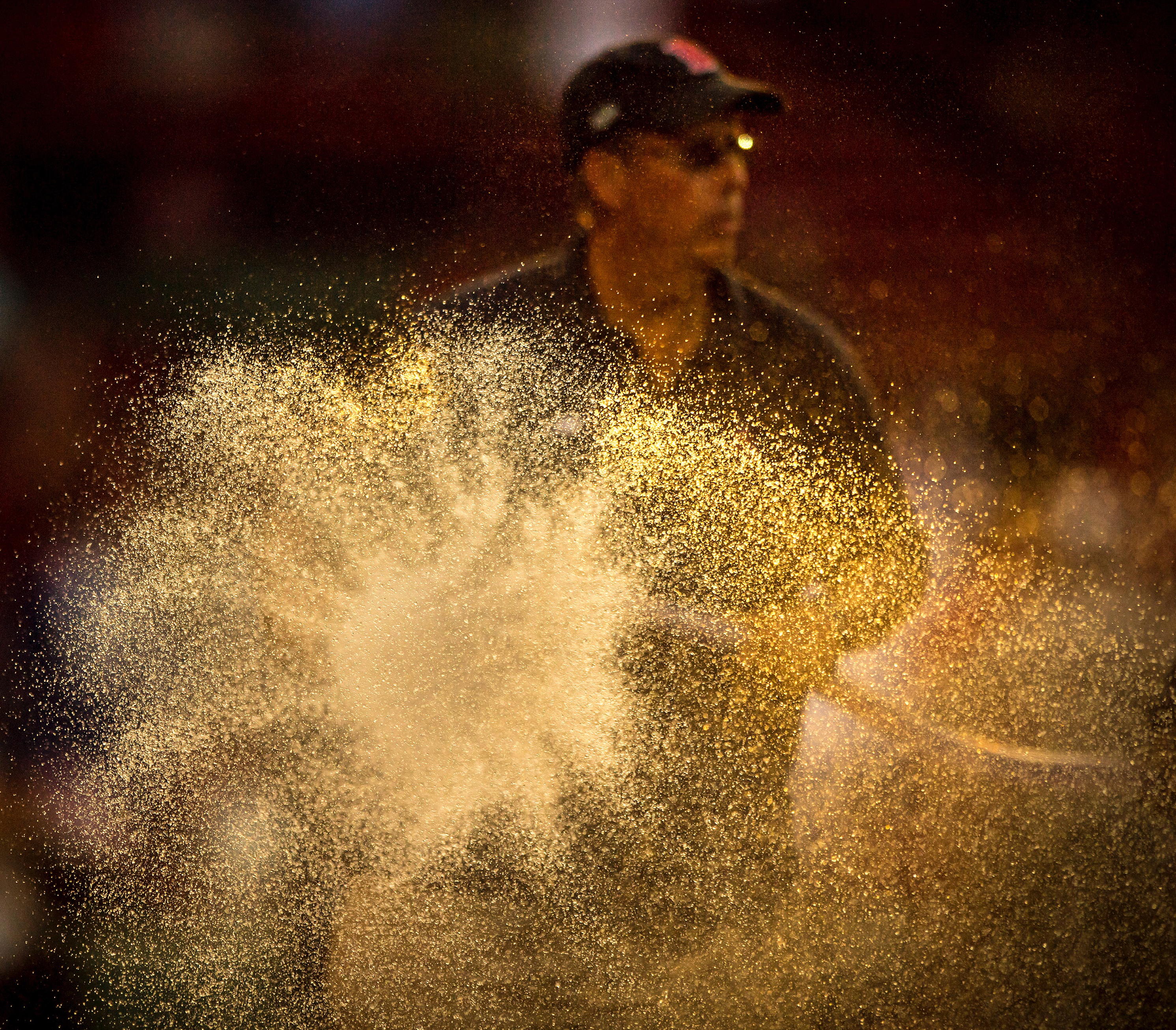 Dave Mellor sprays the hose at Fenway Park.  (Billie Weiss/Boston Red Sox/Getty)
