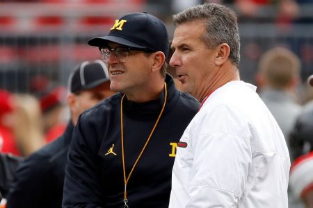 Ex-OSU head coach Urban Meyer and Jim Harbaugh of the Michigan Wolverines. (Gregory Shamus/Getty)