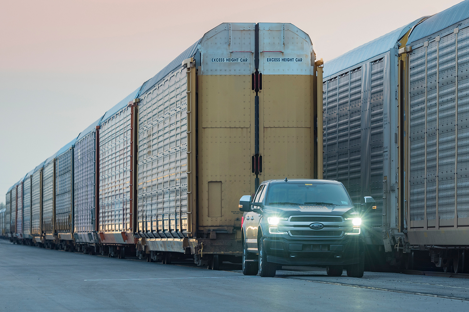 electric ford f-150 pickup towing train cars and trucks