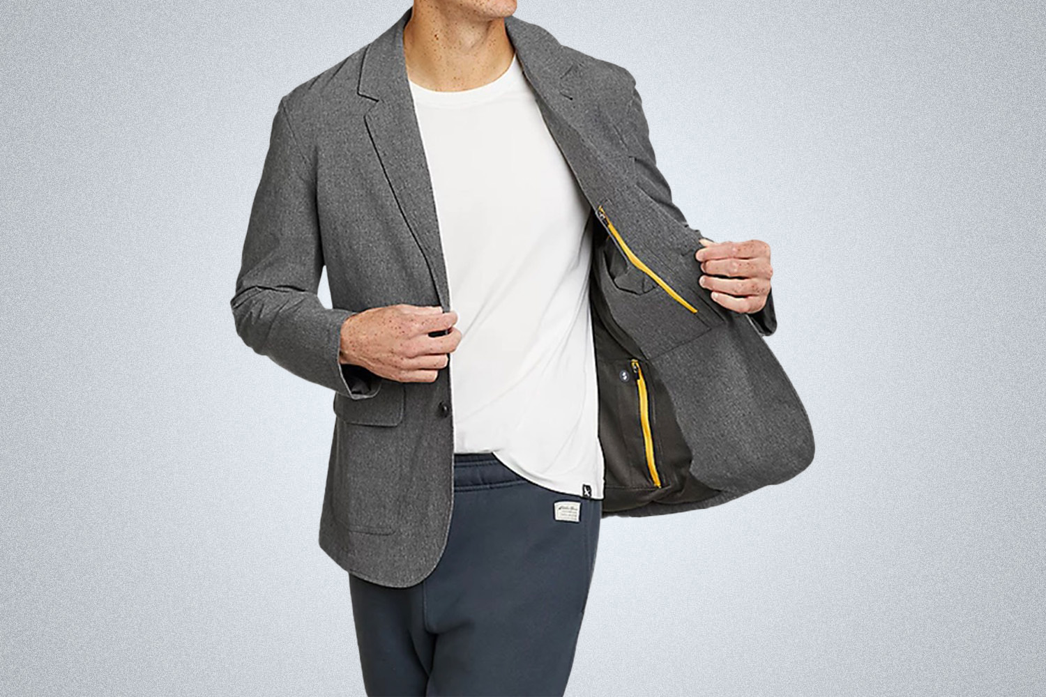 a model in a grey Eddie Bauer travel blazer on a grey background