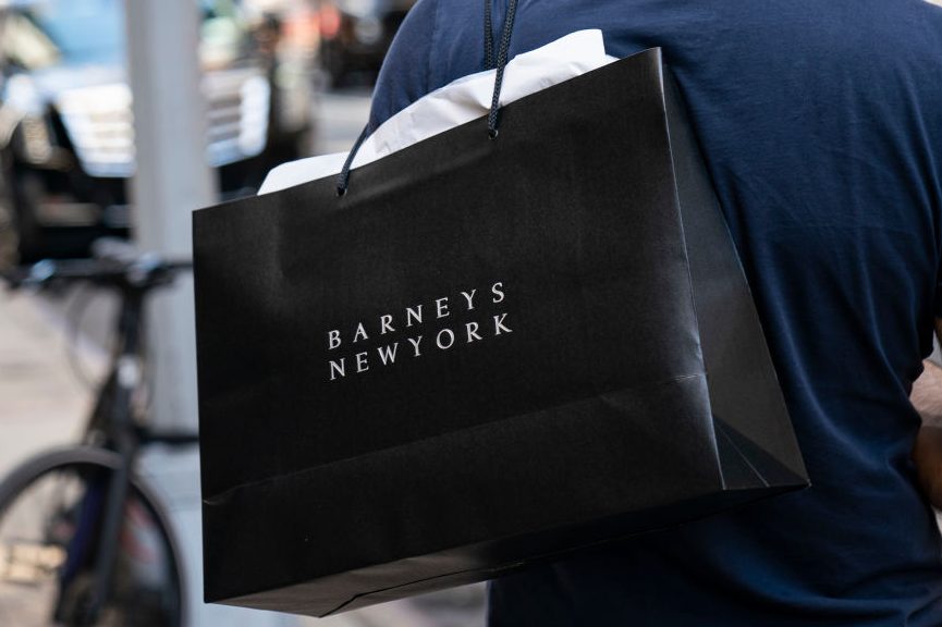 A man carries a Barneys New York shopping bag. (Drew Angerer/Getty)