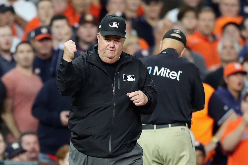 Umpire Joe West calls out Jose Altuve of the Houston Astros (not pictured) on fan interference in the first inning during Game Four of the American League Championship Series between the Boston Red Sox and the Houston Astros at Minute Maid Park on October 17, 2018 in Houston, Texas.  (Photo by Elsa/Getty Images)