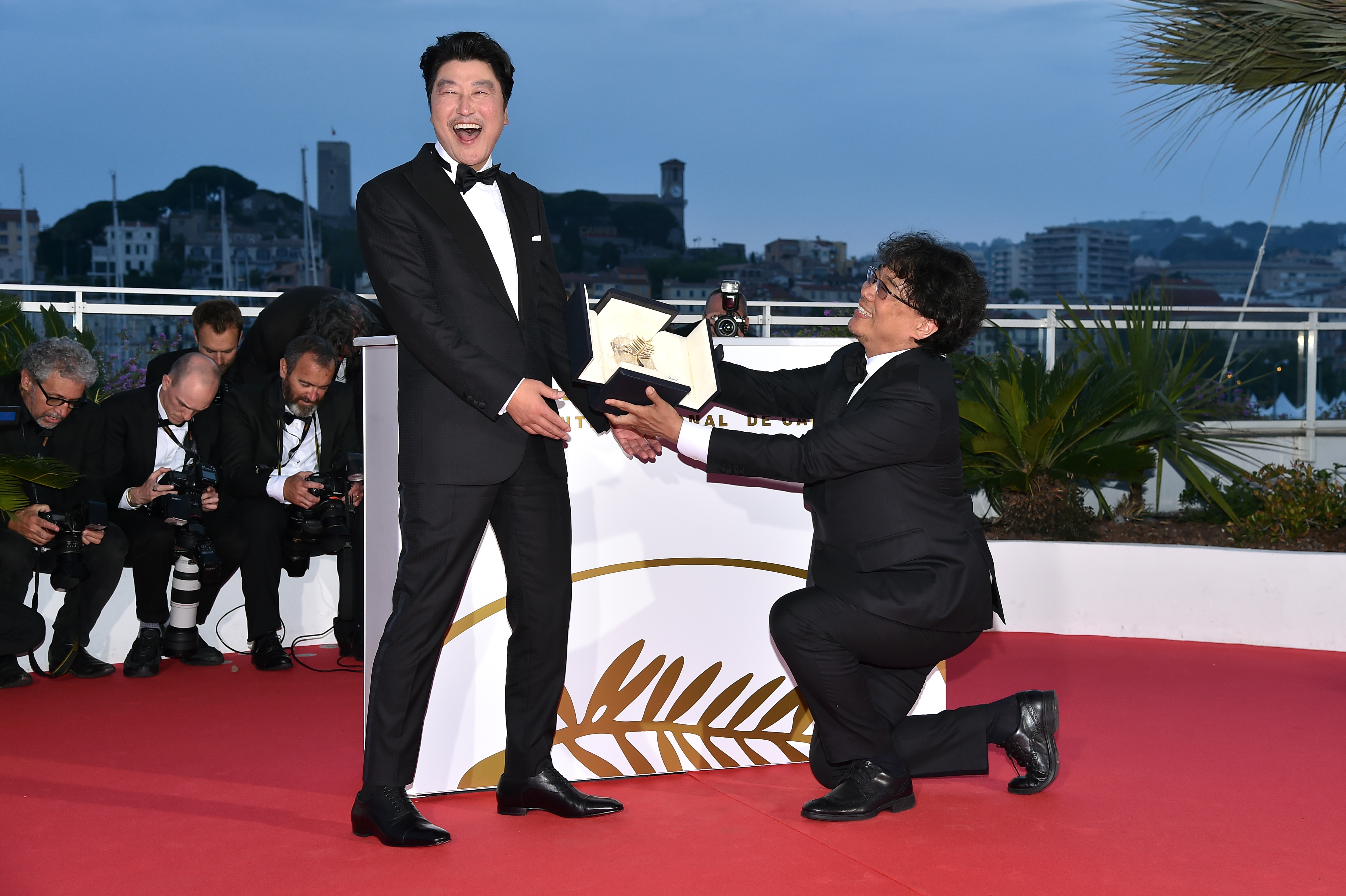 Director Bong Joon-Ho, presents the Palme d'Or award for his film "Parasite" to Kang-Ho Song. (Photo by Dominique Charriau/WireImage)