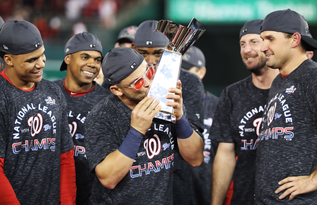 Gerardo Parra #88 of the Washington Nationals celebrates with the trophy after winning game four and the National League Championship Series against the St. Louis Cardinals at Nationals Park on October 15, 2019 in Washington, DC. (Photo by Rob Carr/Getty Images)