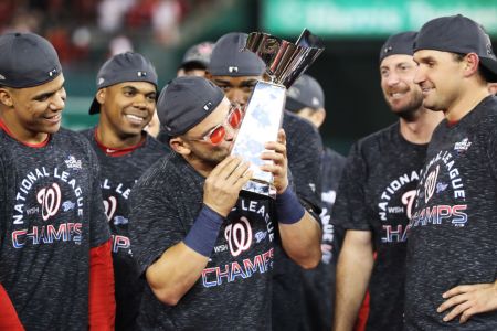 Gerardo Parra #88 of the Washington Nationals celebrates with the trophy after winning game four and the National League Championship Series against the St. Louis Cardinals at Nationals Park on October 15, 2019 in Washington, DC. (Photo by Rob Carr/Getty Images)