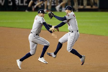 Carlos Correa and George Springer of the Houston Astros celebrate their team's 8-1 win against the Washington Nationals in Game Four of the 2019 World Series at Nationals Park on October 26, 2019 in Washington, DC. (Photo by Will Newton/Getty Images)