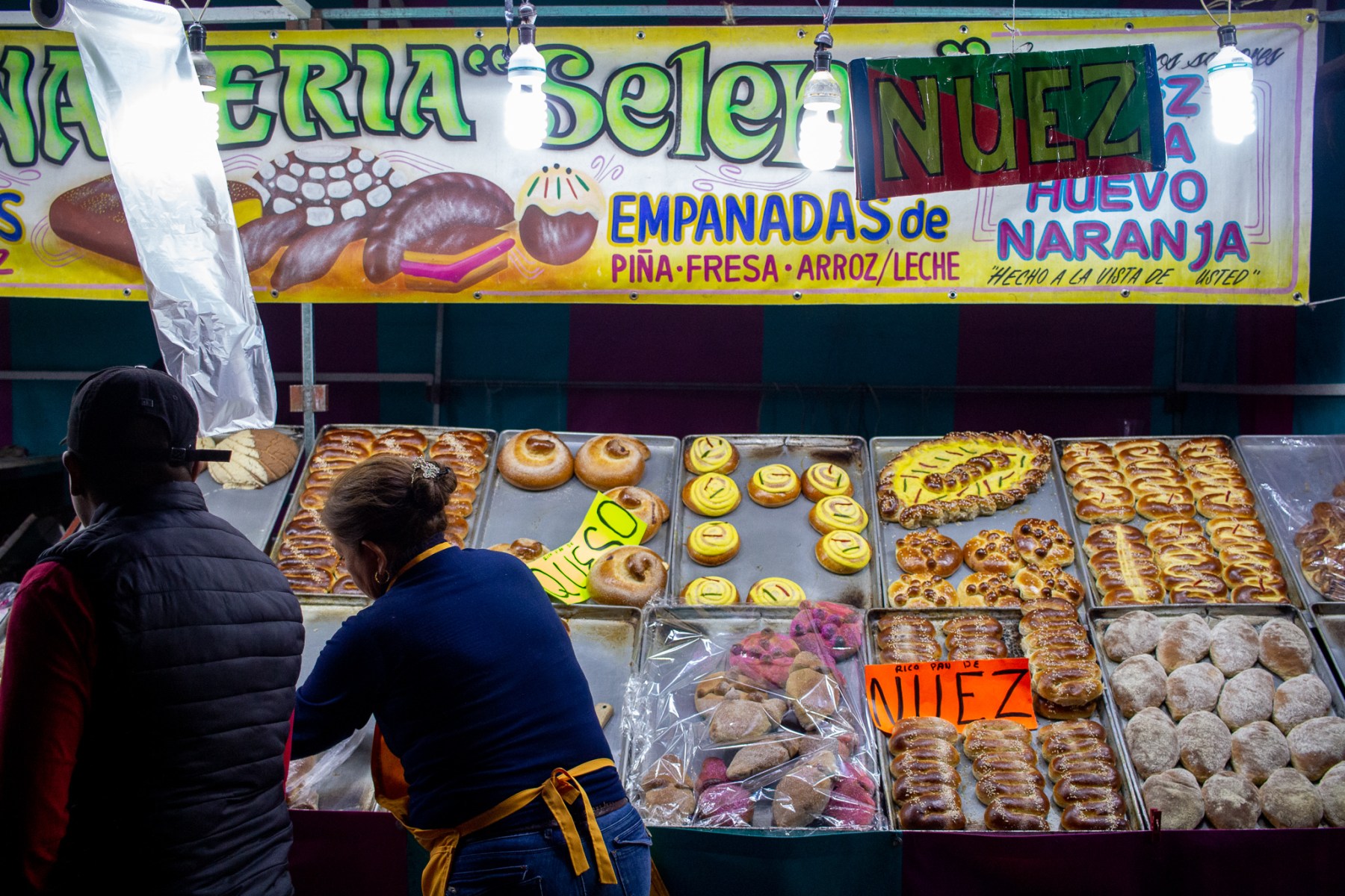 The area outside of the cemetery takes on an almost county fair-like quality, with vendors selling food like Pan de Muerto, a special type of bread eaten during the holiday.