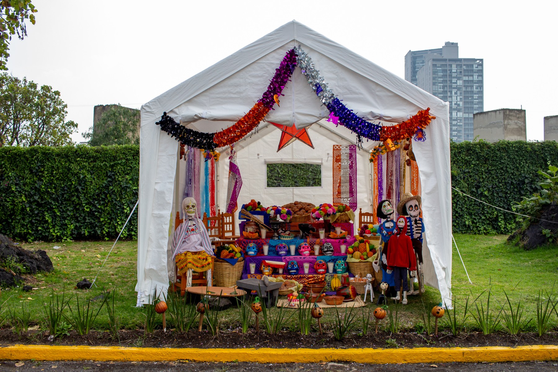 After the celebrations are over, an ofrendas remains standing at a cemetery south of the city. Some of these altars will remain there for weeks before the families take them down.