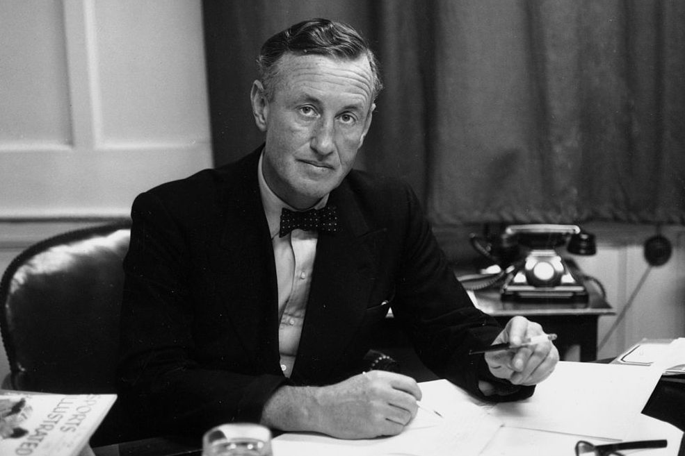 Ian Fleming, British author and creator of James Bond, at his desk. (Photo by Express/Express/Getty)