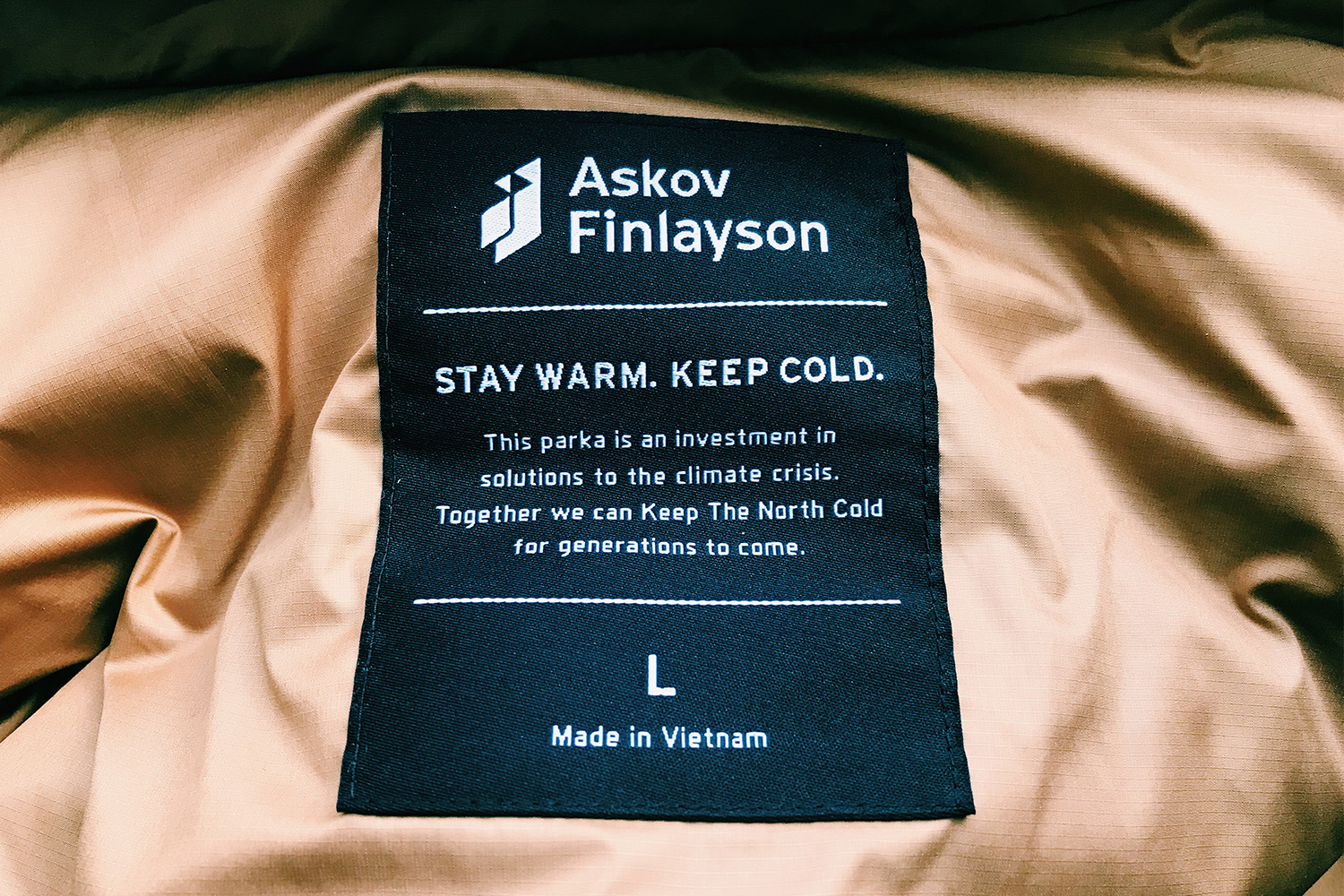 The tag on the inside of Askov Finlayson's climate positive Winter Parka, taken in 2019