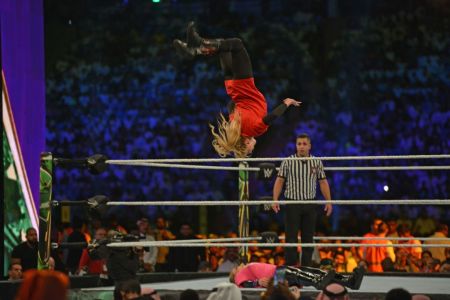Lacey Evans (red) fights against Natalya during the World Wrestling Entertainment (WWE) Crown Jewel pay-per-view in Riyadh on October 31, 2019. (Photo by Fayez Nureldine / AFP) (Photo by FAYEZ NURELDINE/AFP via Getty Images)