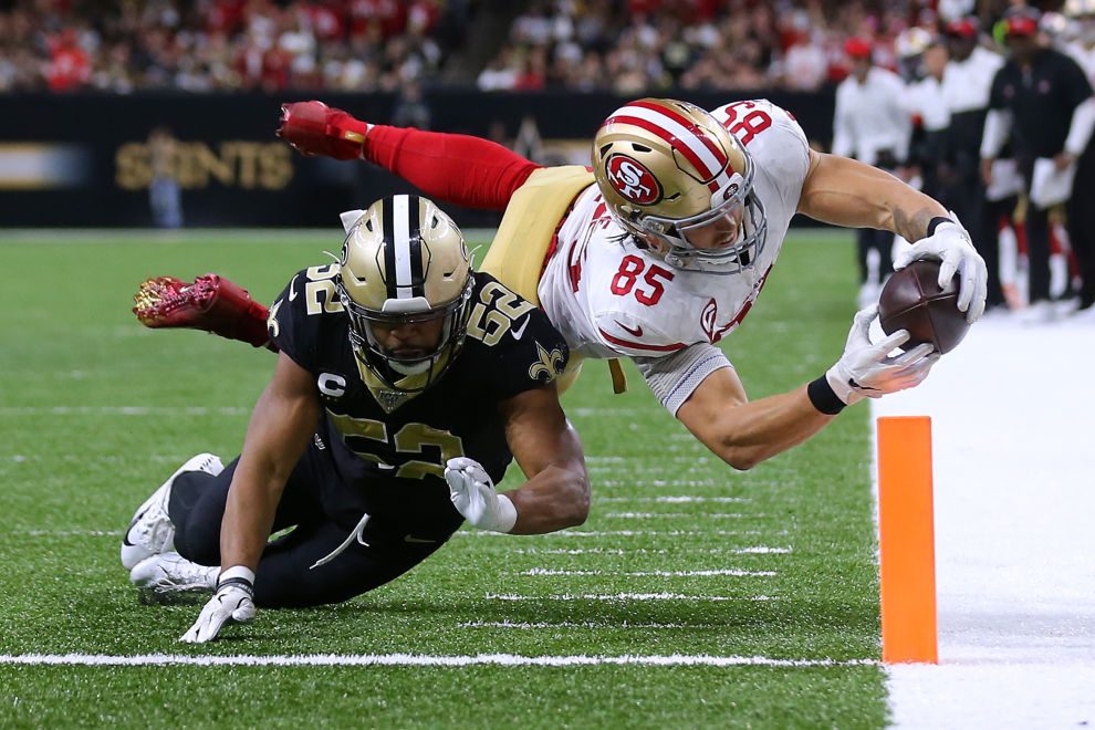George Kittle of the San Francisco 49ers scores a touchdown as Craig Robertson of the New Orleans Saints defends during the second half of a game at the Mercedes Benz Superdome on December 08, 2019 in New Orleans, Louisiana. (Photo by Jonathan Bachman/Getty Images)