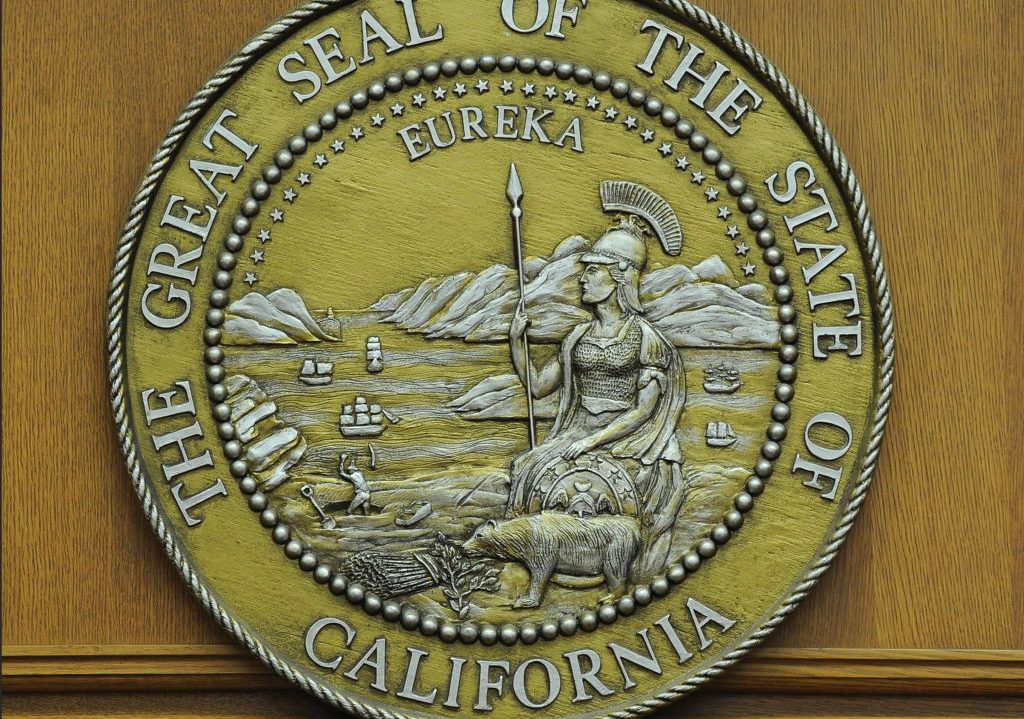 The seal of the state of California hangs in a closed courtroom at the Stanley Mosk Courthouse in downtown Los Angeles.(Photo by Robyn BECK / AFP)     