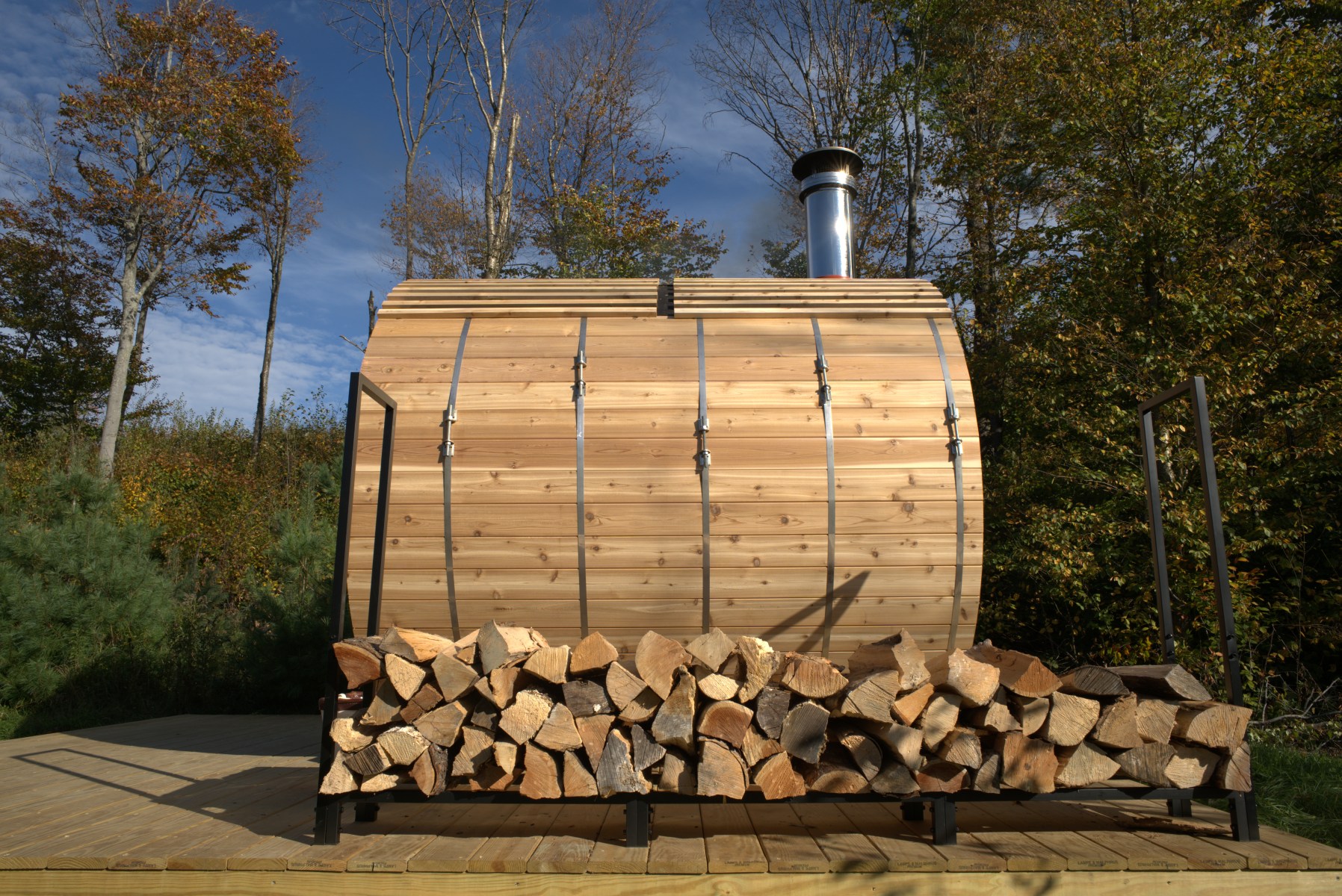 <strong>Choosing Sauna Size and Type</strong><br>"First, you have to decide if you're going indoor or outdoor," Bollman says. "Then, you have to think about how many people you would imagine having in it at a given time and, secondarily, if you want to be able to sit in it or do you want to be able to lie down in it. You also need to decide if your heat source will be electric or wood-burning. The latter takes up significantly more space, but you get the crackle of the wood and you also get the natural light of the fire passing through ... I put it on a piece of the property that's fully off grid — but there's so much wood."