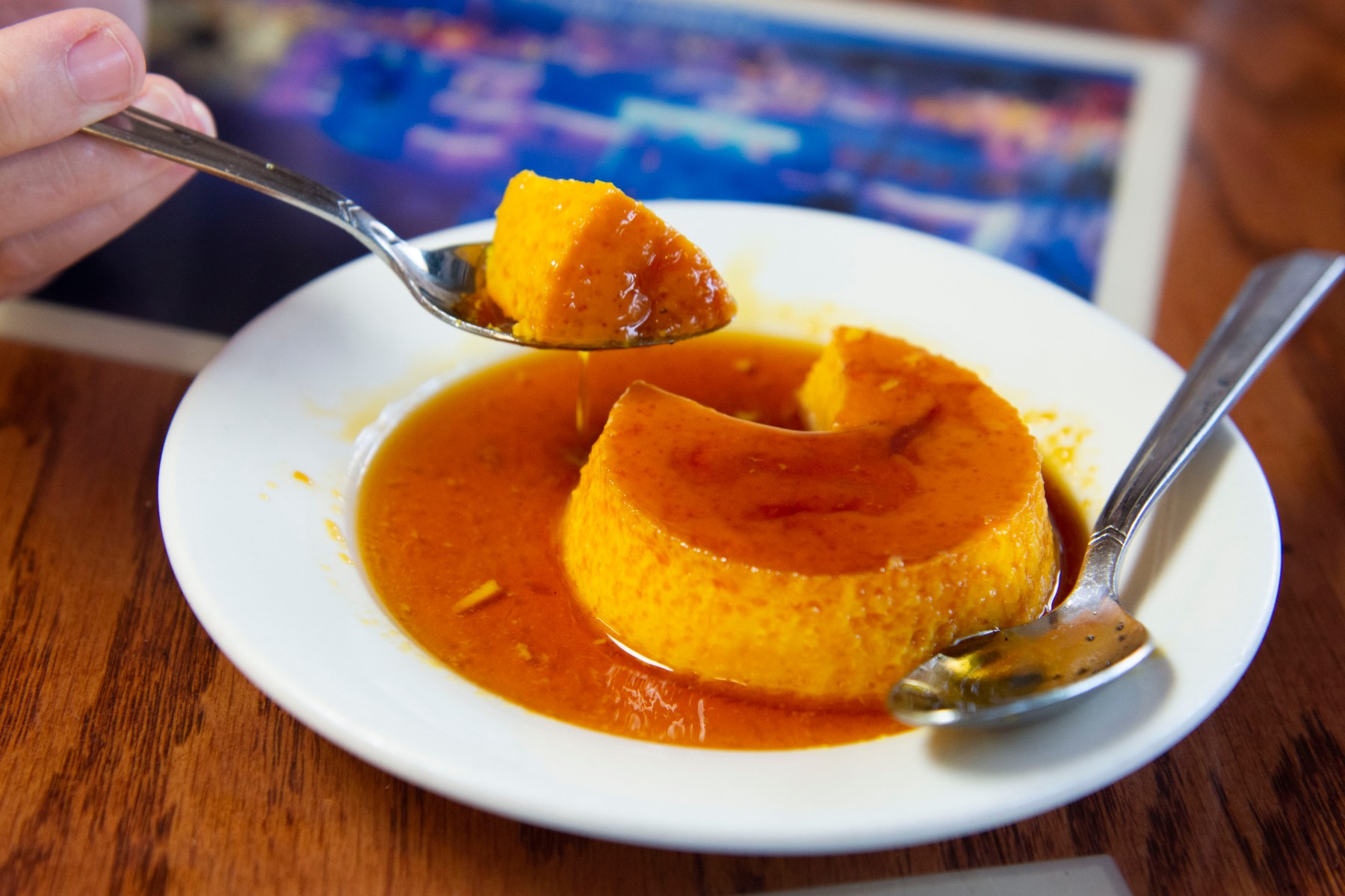 And actually, we do have room. Because how can you leave an iconic Cuban restaurant without trying<br>their flan? It arrives in all of its ooey, gooey, caramel-y goodness, and while we say “Just one spoonful!”<br>we know we’re lying to each other. It’s too good to resist, jiggling first on the plate then floating on our<br>tongues.