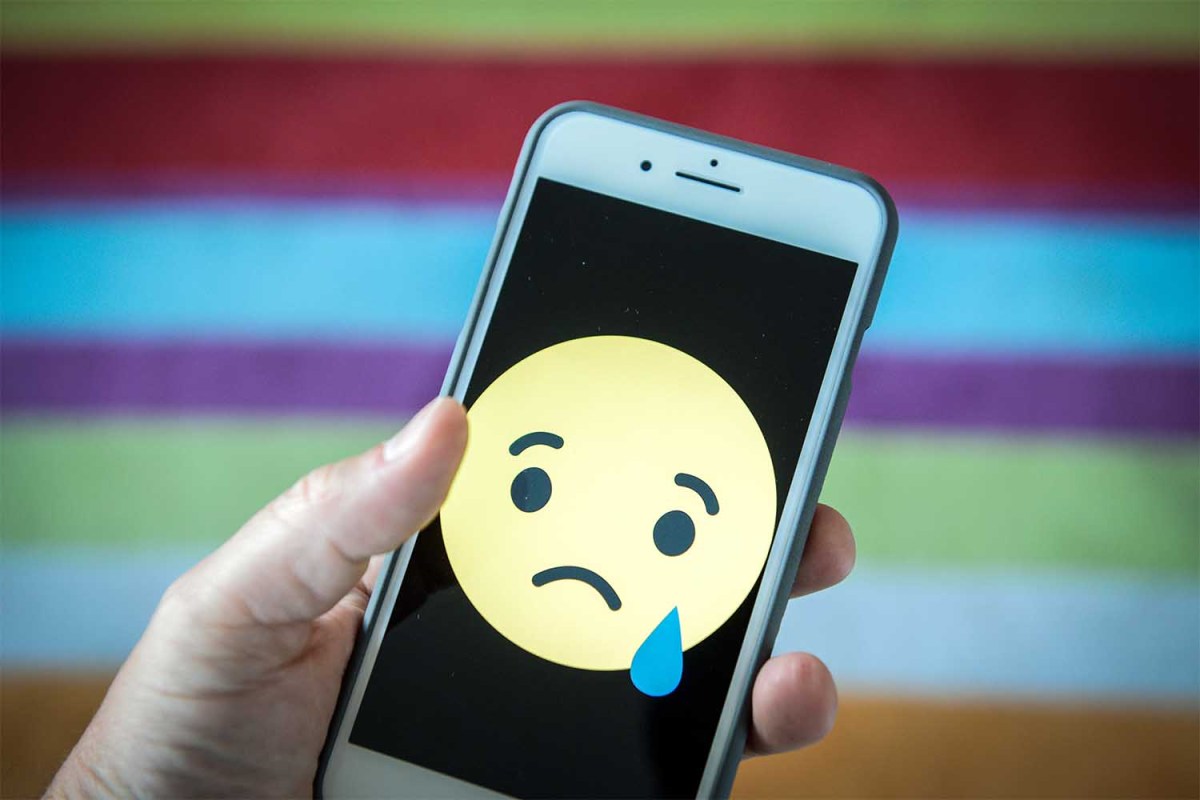 Sad face emoji on a phone
