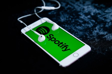 iphone with headphones playing Spotify