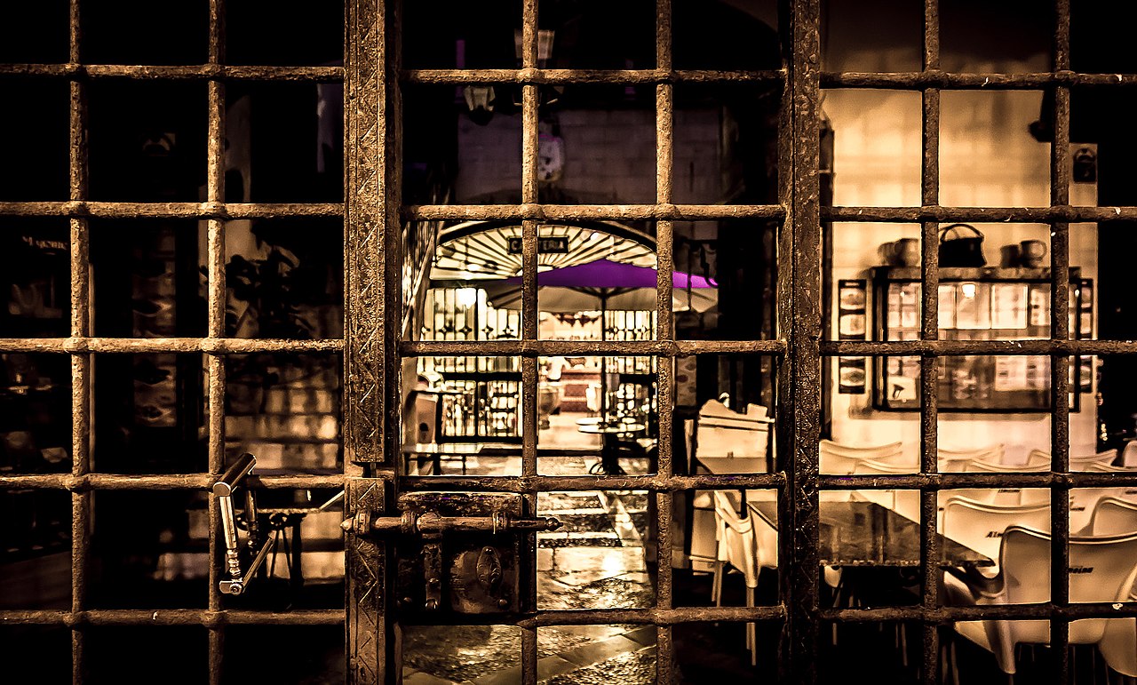 Locked gate, restaurant beyond