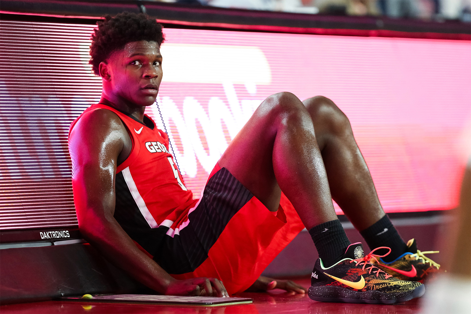 Basketball player sitting on the court