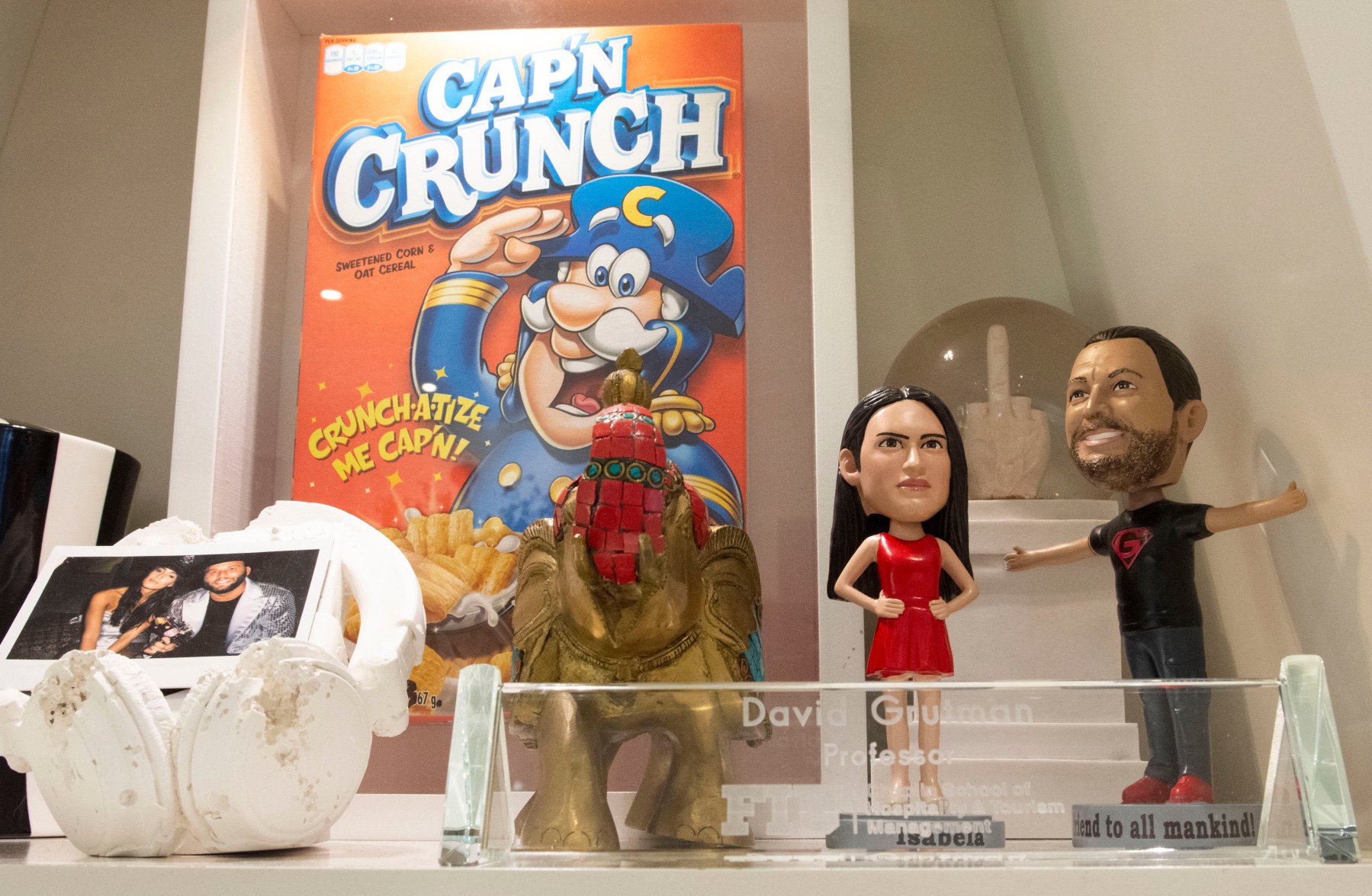 Bobbleheads of Grutman and his wife, model Isabela Rangel, alongside a Captain Crunch box by artist Peter Tunney. 