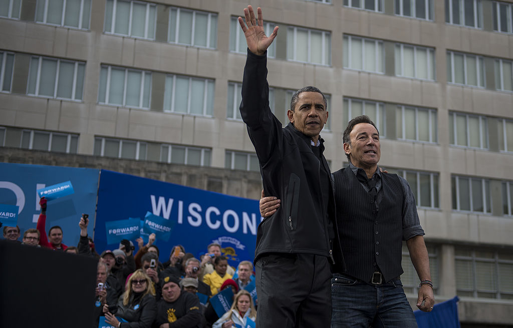 President Barack Obama alongside Bruce Springsteen waves to the crowd during a campaign stop in Madison, Wisconsin, on Monday, November 5, 2012. (Photo by Nikki Kahn/The Washington Post via Getty Images)