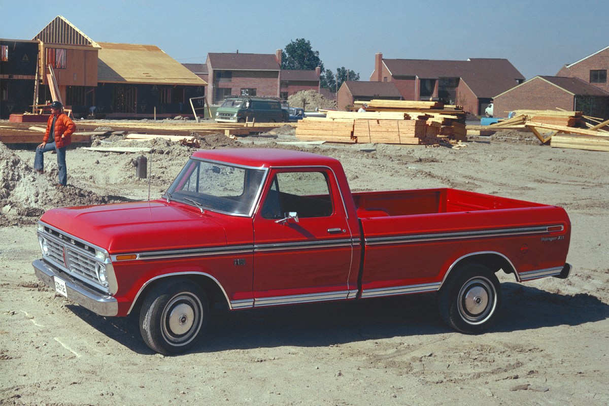Old-school red Ford pickup truck on a worksite