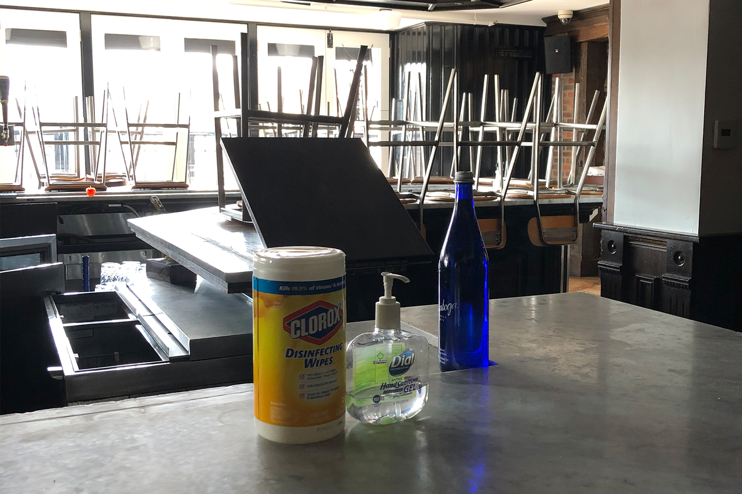 A bottle of water, Clorox wipes and hand sanitizer at The Fox & Falcon