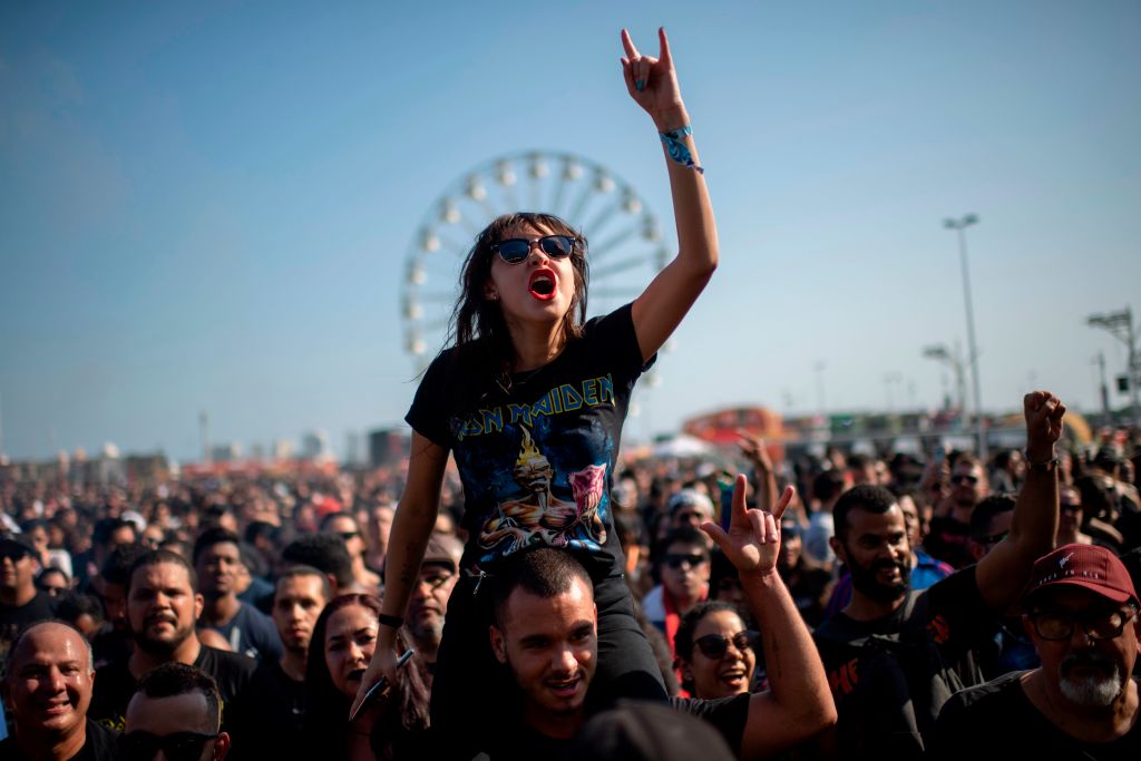 Fans of Brazilian rock band Nervosa enjoy the concert on the Sunset stage during the Rock in Rio festival 2019 at the Olympic Park. (Photo by MAURO PIMENTEL/AFP via Getty Images)