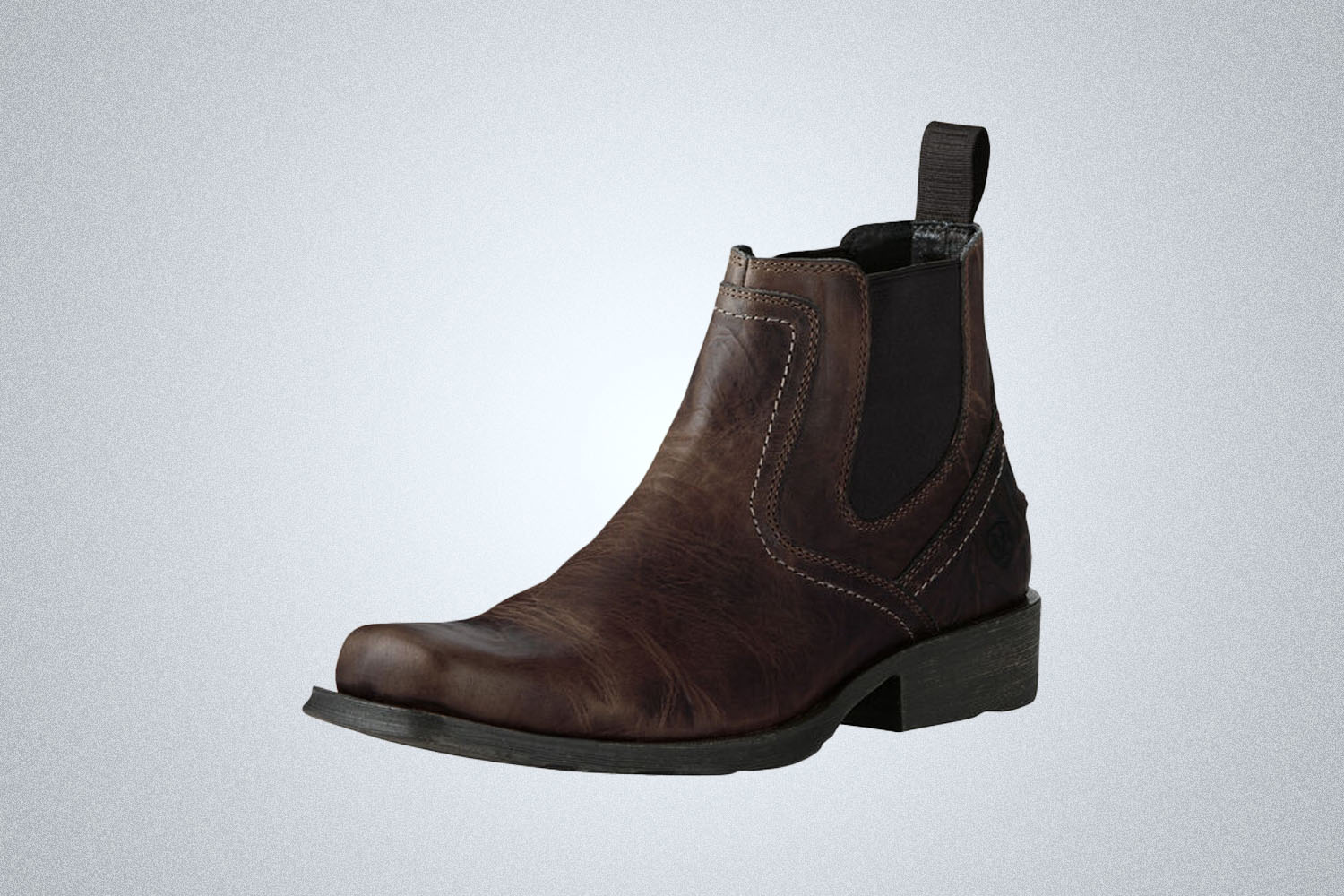 a leather Ariat chelsea boot on a grey background