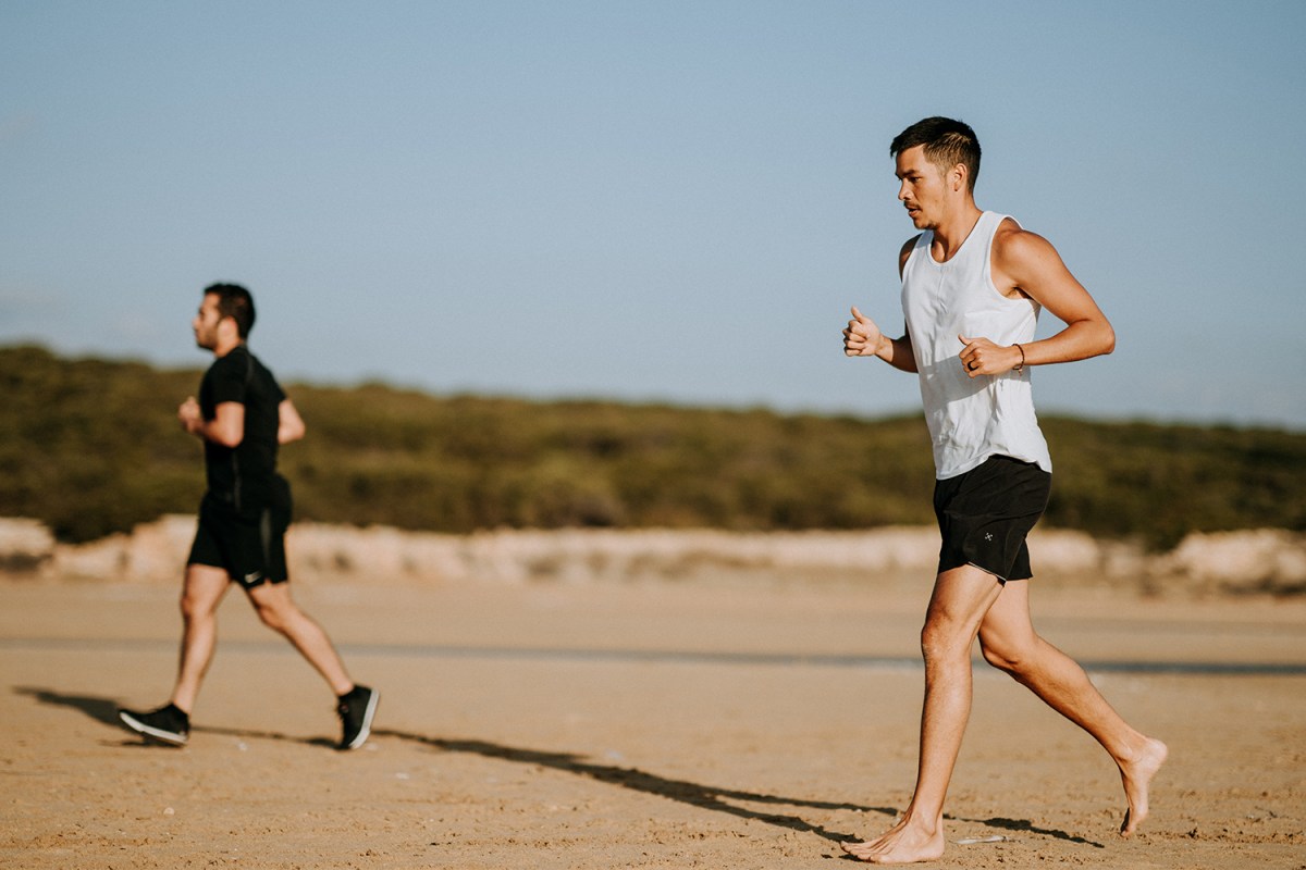 Two runners on a beach