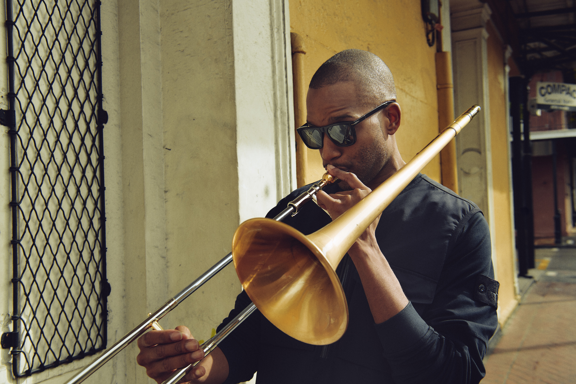 Trombone Shorty wearing David Beckham Sun and Stone Island in the French Quarter