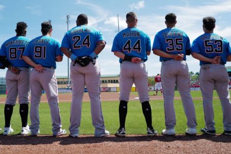 Miami Marlins stand during the National Anthem before a spring training game. (Mark Brown/Getty)